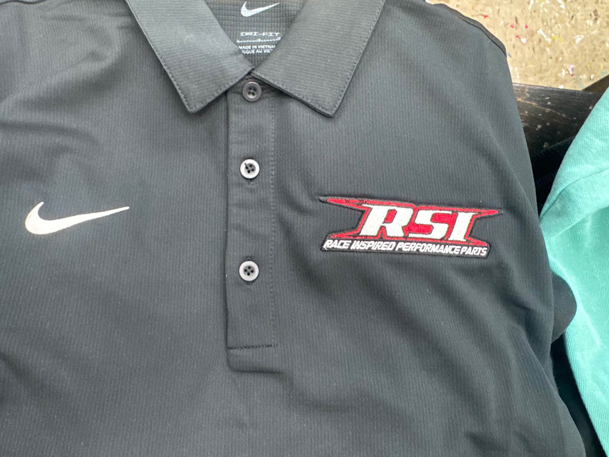 Nike polo with red logo on the breast